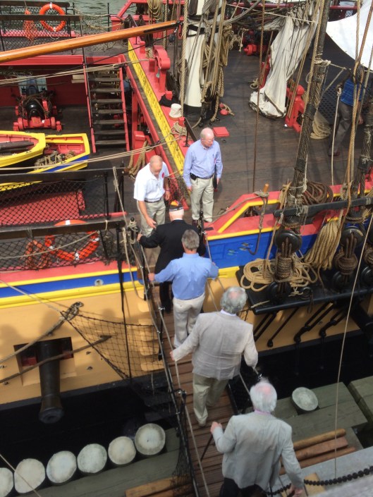 An aging WW2 veterans is escorted onto the Hermione, July 3, 2015